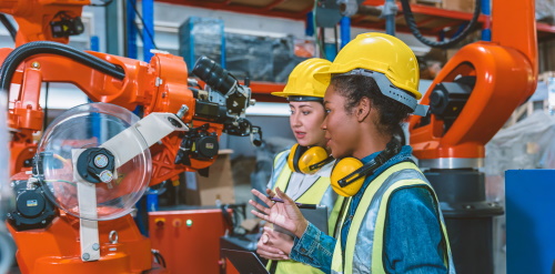 This image: an illustrative photo of two female workers in a factory. 
							The map: the map shows the Thrive site boundary in the context of current employment 
							sites and allocations in orange.